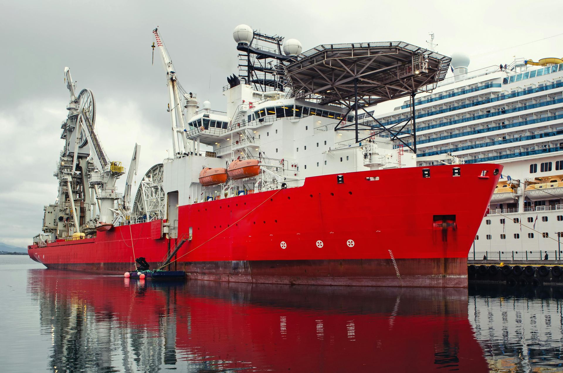 Offshore support vessel docked at an industrial port terminal