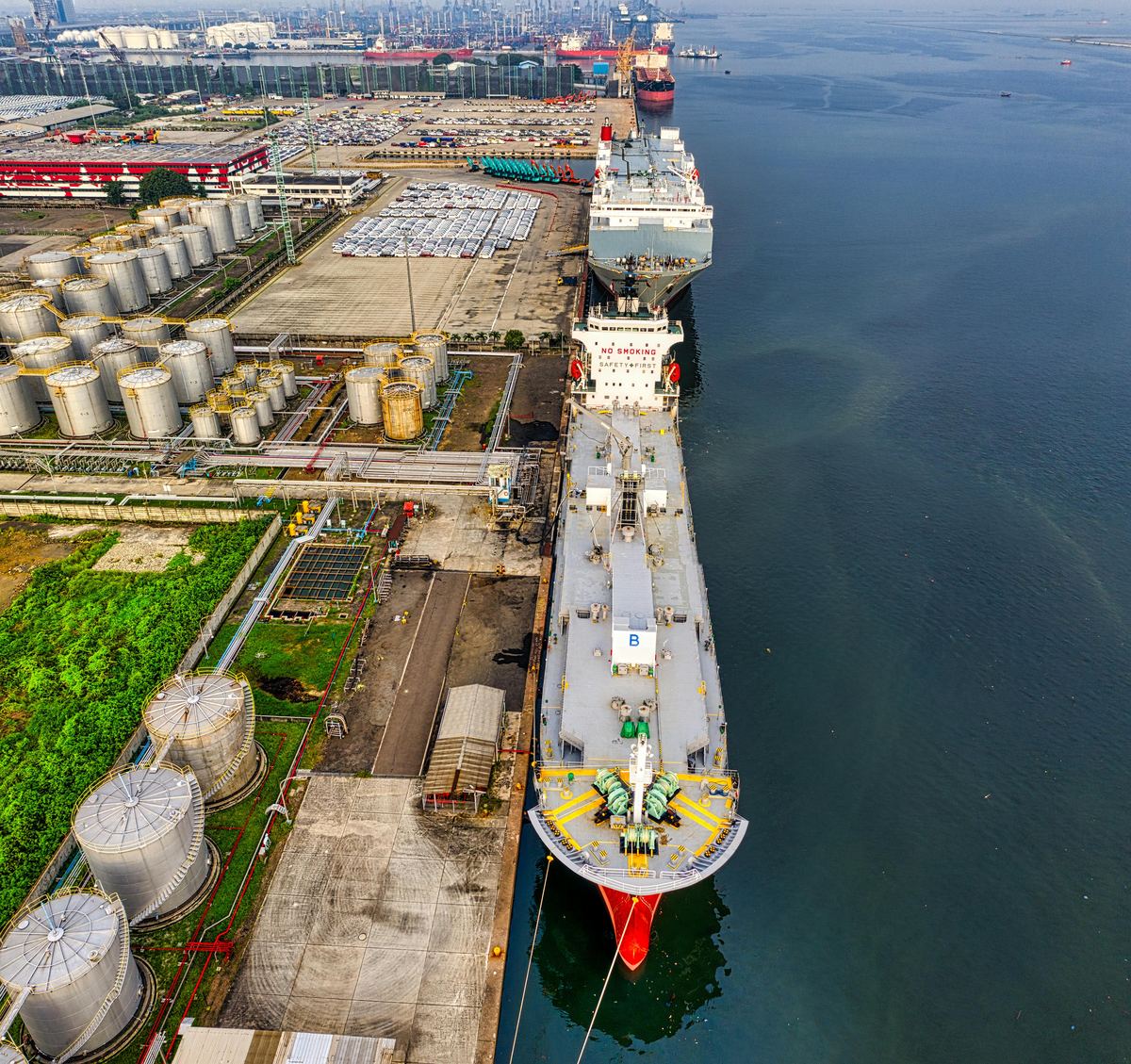 Aerial view of an oil terminal with storage tanks and tankers