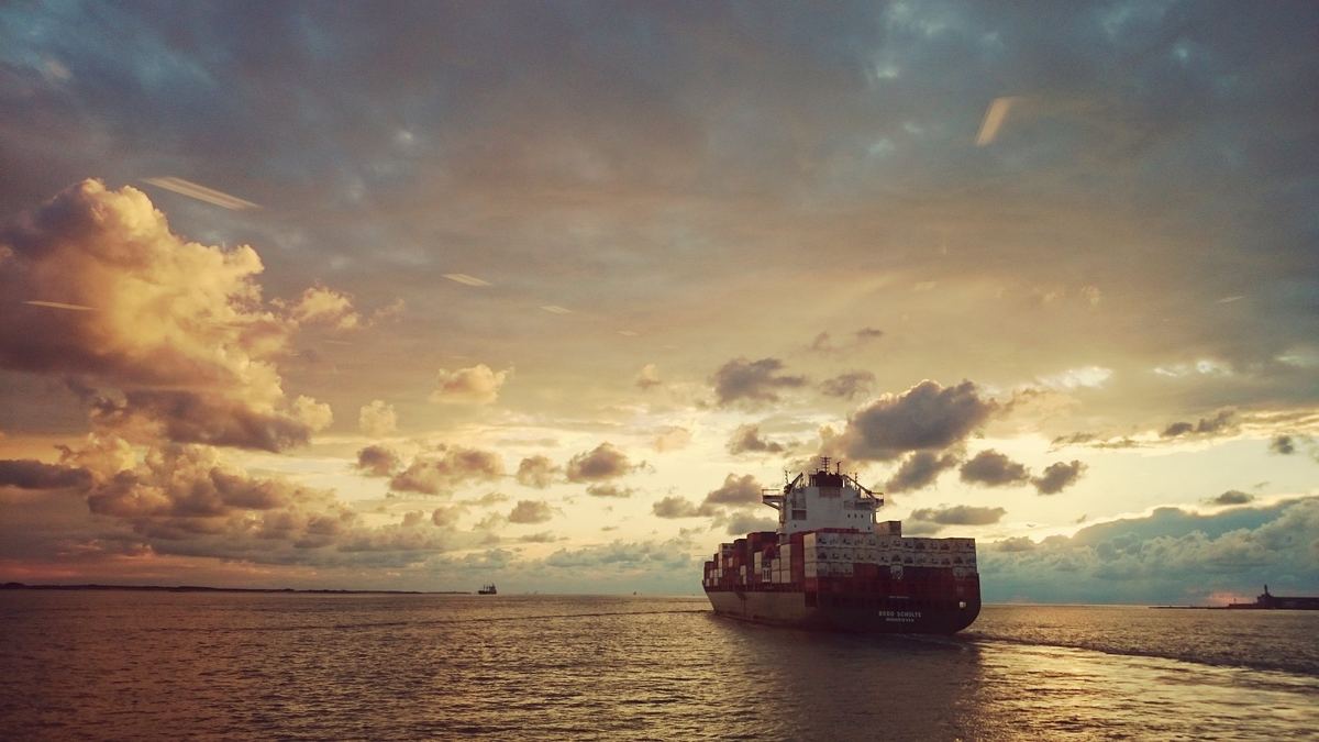 Container ship at sea during sunset
